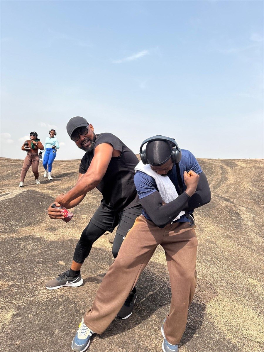 Mr Jide Animola and gym members flexing at the Dutse mountain summit