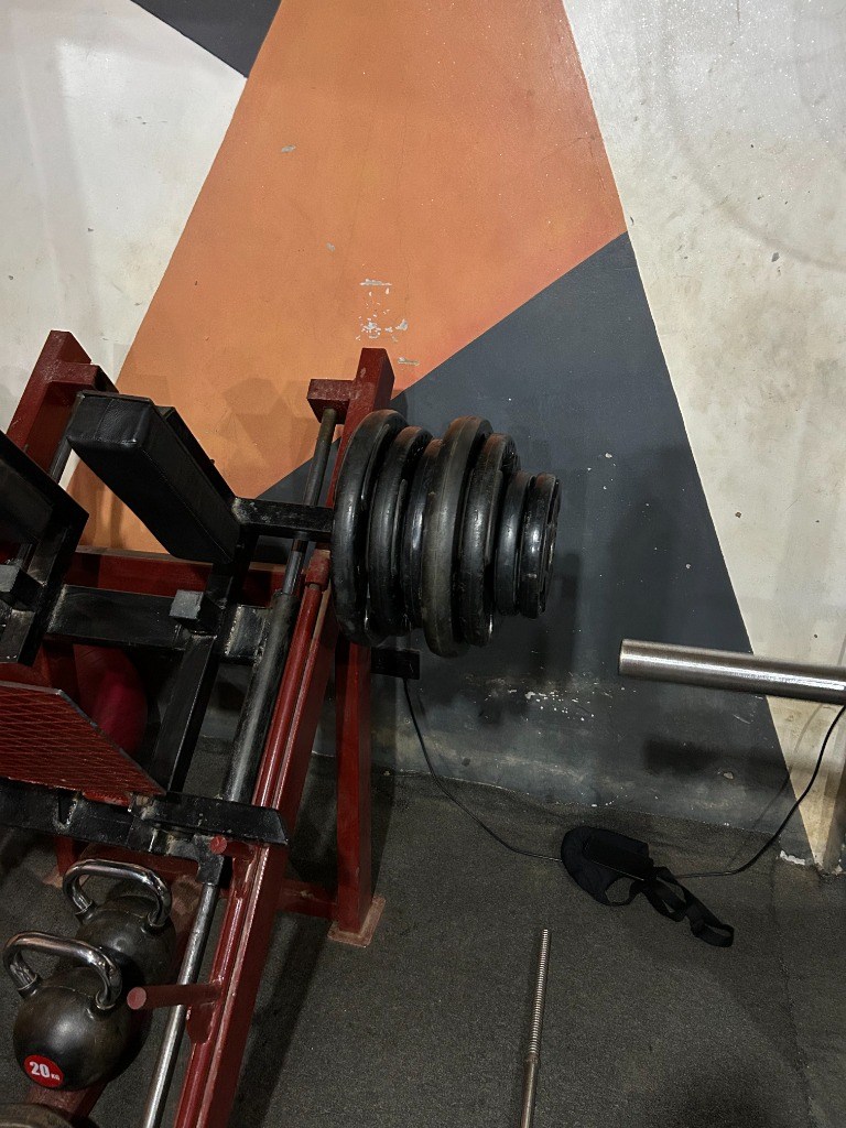 Heavy plate-loaded leg press machine and kettlebells at G:Lite Hub